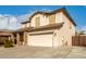 Two story home featuring a front yard, neutral color scheme, and a two-car garage at 11128 E Segura Ave, Mesa, AZ 85212