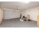 Spacious garage with a large roll up door, concrete floors, and ample storage space at 11128 E Segura Ave, Mesa, AZ 85212