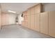 Garage features neutral walls, concrete floors and built-in shelving for plenty of storage at 11128 E Segura Ave, Mesa, AZ 85212