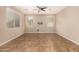 Bright living room with tile flooring, ceiling fan, and a wall-mounted television setup at 11128 E Segura Ave, Mesa, AZ 85212