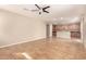 Open-concept living room featuring tile flooring and a ceiling fan connecting to the kitchen at 11128 E Segura Ave, Mesa, AZ 85212