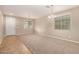 Spacious living room with carpet flooring, ample natural light, and a modern chandelier at 11128 E Segura Ave, Mesa, AZ 85212