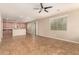 Open-concept kitchen and living room featuring tile flooring, cabinets and a ceiling fan at 11128 E Segura Ave, Mesa, AZ 85212