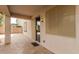 Covered patio featuring tile flooring and a sliding glass door to the home's interior at 11128 E Segura Ave, Mesa, AZ 85212