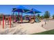 Neighborhood playground featuring colorful play structures, slides, and sun shades at 11128 E Segura Ave, Mesa, AZ 85212