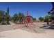 Outdoor playground with rope climbing structure and slides near houses and trees at 11128 E Segura Ave, Mesa, AZ 85212