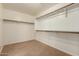 A walk-in closet with multiple shelves and rods for optimal storage at 11128 E Segura Ave, Mesa, AZ 85212