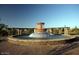 A calming water fountain in a community area with stone structures, water, and beautiful surroundings at 11128 E Segura Ave, Mesa, AZ 85212