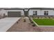 Beautiful single-story home featuring a low maintenance yard with rock landscaping and a covered two car garage at 11206 E Crescent Ave, Mesa, AZ 85208