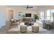 Bright living room with modern decor, neutral colors, and a large window that fills the space with natural light at 11206 E Crescent Ave, Mesa, AZ 85208