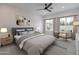 Relaxing bedroom with a large bed, soft rug, ceiling fan and ample natural light from the dual windows at 11206 E Crescent Ave, Mesa, AZ 85208