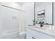 Bright bathroom featuring modern fixtures, neutral color palette, and tiled shower/tub at 11230 E Crescent Ave, Mesa, AZ 85208