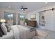 Serene main bedroom features large windows, a ceiling fan, and ensuite bathroom with tub at 11230 E Crescent Ave, Mesa, AZ 85208