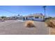 Expansive backyard featuring desert landscaping, a covered patio, and views of neighboring homes at 11407 N 111Th Ave, Sun City, AZ 85351