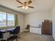 Bright bedroom with a large window, desk, and brick accent wall, creating a comfortable and inviting space at 11407 N 111Th Ave, Sun City, AZ 85351