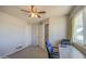 Versatile bedroom featuring neutral walls, a large window, and soft carpet, perfect for work and rest at 11407 N 111Th Ave, Sun City, AZ 85351