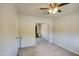 Bright bedroom showcasing a mirrored closet, soft carpet, and neutral brick wall, illuminated by natural light at 11407 N 111Th Ave, Sun City, AZ 85351