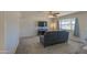 Bright living room with a large window and ceiling fan, creating a comfortable space at 11407 N 111Th Ave, Sun City, AZ 85351