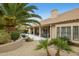 A view of the backyard featuring a pool, a covered patio, and lush greenery at 12610 E Cortez Dr, Scottsdale, AZ 85259