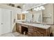 Elegant bathroom features dual sinks, granite countertops, custom cabinetry, and a well-lit vanity area at 12610 E Cortez Dr, Scottsdale, AZ 85259