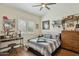 Cozy bedroom with wood flooring, a ceiling fan, a well-lit desk, and a fun decorative theme at 12610 E Cortez Dr, Scottsdale, AZ 85259