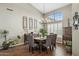 Chic dining area featuring hardwood floors, a grand window, a chandelier and elegant furnishings at 12610 E Cortez Dr, Scottsdale, AZ 85259