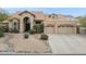 Elegant home featuring a landscaped front yard, a spacious three-car garage, and a tile roof at 12610 E Cortez Dr, Scottsdale, AZ 85259