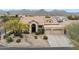 Inviting single-Gathering home with three-car garage, tile roof, and desert landscaping at 12610 E Cortez Dr, Scottsdale, AZ 85259