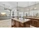 Open-concept kitchen features granite countertops, an island cooktop, and seamlessly connects to the living area at 12610 E Cortez Dr, Scottsdale, AZ 85259