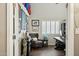 View of a home office with a desk, chair, and decor, leading to the entrance of the room at 12610 E Cortez Dr, Scottsdale, AZ 85259