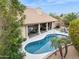 Beautiful pool area with covered patio seating and lush tropical landscaping at 12610 E Cortez Dr, Scottsdale, AZ 85259