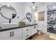 Modern bathroom featuring double sinks, square tile, and a decorative shower at 13845 N 41St Ave, Phoenix, AZ 85053