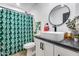 Nicely finished bathroom featuring a toilet, shower with patterned curtain, and modern vanity with stylish fixtures at 13845 N 41St Ave, Phoenix, AZ 85053