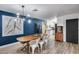 A modern dining room featuring wood table and seating with easy access to kitchen at 13845 N 41St Ave, Phoenix, AZ 85053