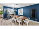 A modern dining area with a wooden table, and an open floor plan to other living spaces at 13845 N 41St Ave, Phoenix, AZ 85053