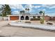 Charming single-story home with arched entryway, decorative front yard, and desert landscaping details at 13845 N 41St Ave, Phoenix, AZ 85053