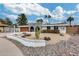 Attractive single-story home with arched entryway, well-maintained lawn, and mature palm trees at 13845 N 41St Ave, Phoenix, AZ 85053