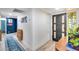 Hallway featuring wood-look floors, white walls, and a dark front door with decorative glass at 13845 N 41St Ave, Phoenix, AZ 85053