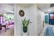 Hallway with view into the living room, featuring light-colored wood floors and white walls at 13845 N 41St Ave, Phoenix, AZ 85053