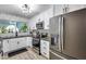 A modern kitchen featuring white cabinetry, stainless steel appliances, and geometric backsplash at 13845 N 41St Ave, Phoenix, AZ 85053