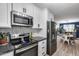 Modern kitchen featuring updated appliances and white cabinets at 13845 N 41St Ave, Phoenix, AZ 85053