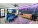 Bright living room with comfortable seating, rug, hanging plants, and a combination of blue and wooden design at 13845 N 41St Ave, Phoenix, AZ 85053