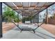 Relaxing backyard pergola with a hammock and bench swing in a tranquil desert landscape at 13845 N 41St Ave, Phoenix, AZ 85053