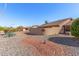 The backyard features desert landscaping and a stucco privacy wall at 14718 W Ravenswood Dr, Sun City West, AZ 85375