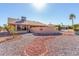 The backyard features desert landscaping and a privacy wall with decorative accents at 14718 W Ravenswood Dr, Sun City West, AZ 85375