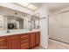 Bathroom features a double vanity, ample cabinet storage space, a large mirror, and a separate shower room at 14718 W Ravenswood Dr, Sun City West, AZ 85375