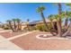 Single-Gathering home with desert landscaping, palm trees, and solar panels on the roof at 14718 W Ravenswood Dr, Sun City West, AZ 85375