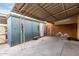 Covered back patio featuring a metal roof, privacy walls, and concrete flooring, ideal for relaxing or entertaining at 1578 W Campbell Ave, Phoenix, AZ 85015