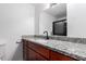 Well-lit bathroom featuring granite counters, dark wood cabinets, and white painted walls at 1578 W Campbell Ave, Phoenix, AZ 85015