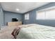 Bright bedroom with carpet, two windows with blinds, and a media center against the wall at 1578 W Campbell Ave, Phoenix, AZ 85015